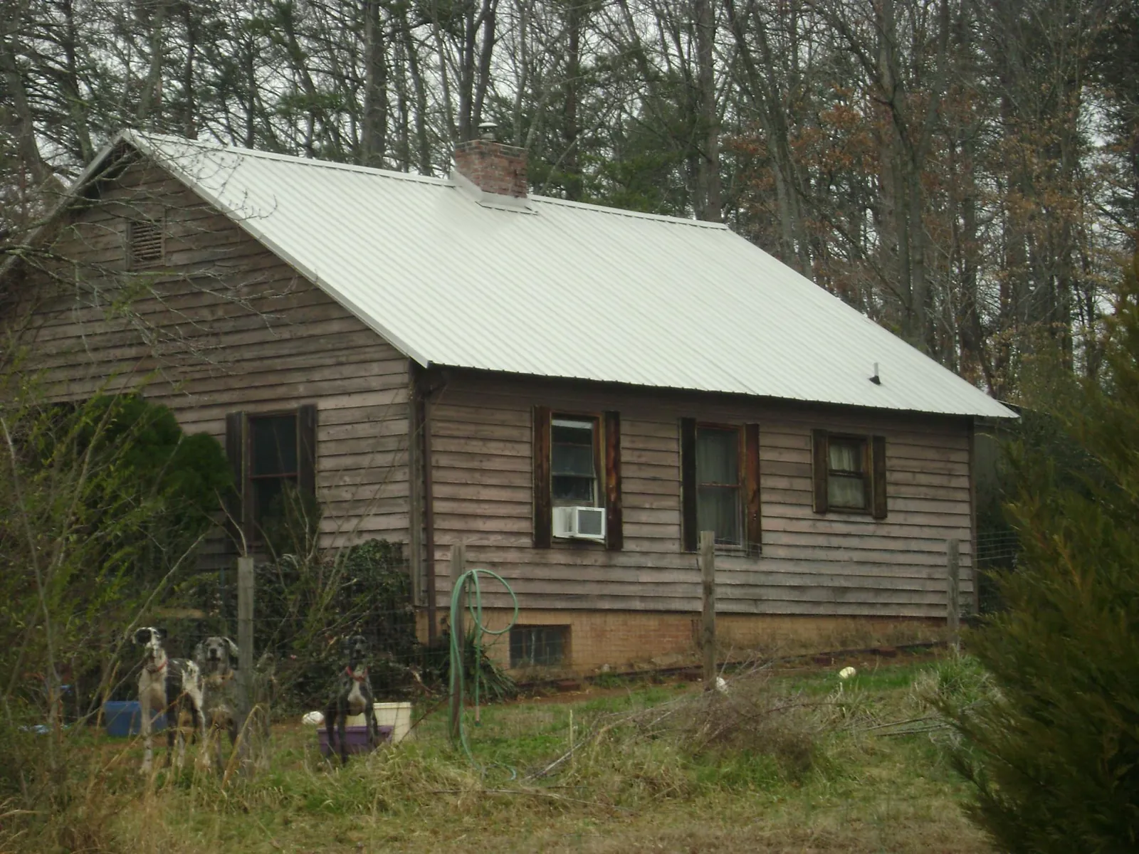 White metal roof on an old wood sided farmhouse, from a Metal Roof Installation job in Peebles